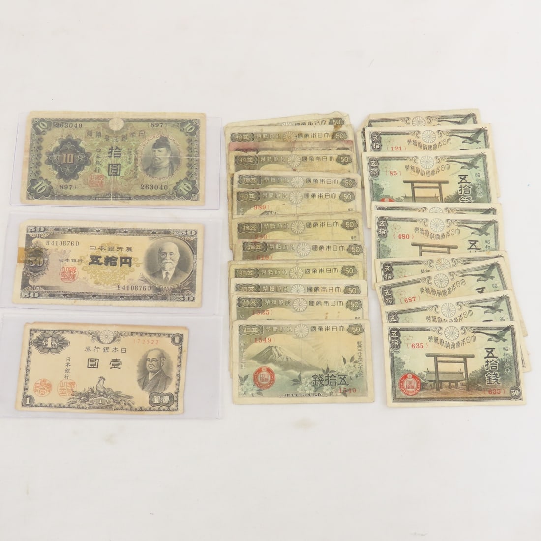 30+ WWII Japanese Currency Notes: 30+ WWII Japanese Currency Notes - 10 Yasukuni Shrine 50 Sen, 20 Mt Fuji 50 Sen, 1 Yen, 10 Yen, & 50 Yen notes. Lot Size 8x4x1" 1 LB All information and photos are intended to be as accurate as