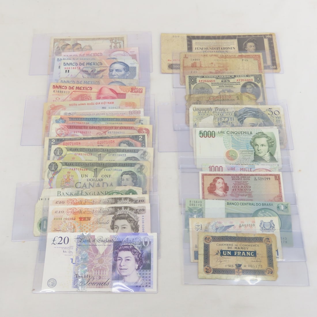 Modern & Vintage World Currency Collection: Modern & Vintage World Currency Collection - Bank of England 20, 10x2, & 1 pound notes, Canada $1, $2 & $5 Notes ($11 total), Italy, Mexico, France and other currency in plastic protectors. Lot Size 8