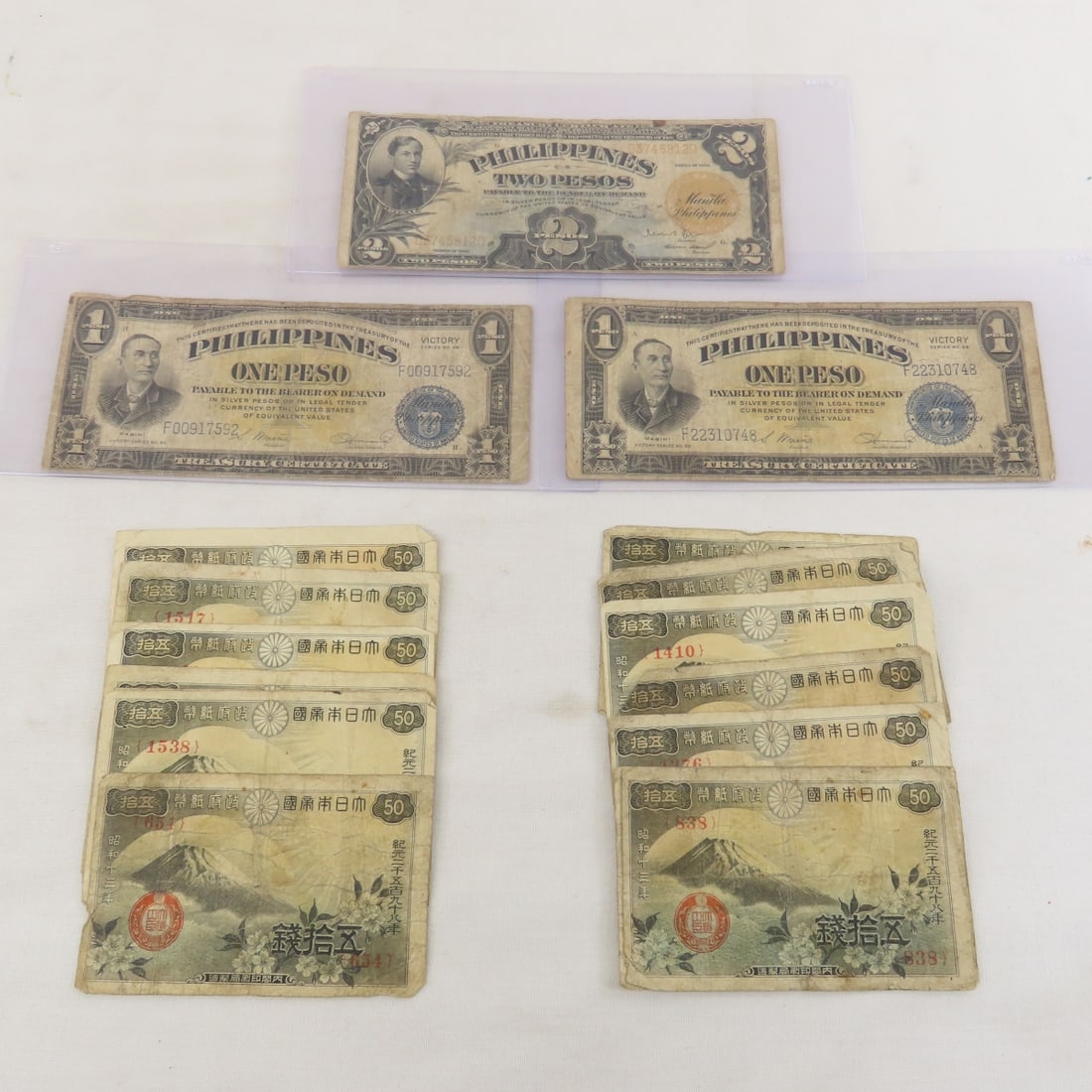 WWII Philippines Victory Notes, Short Snorter: WWII Philippines Victory Notes, Short Snorter - 10 50 Sen notes, 2 Series 66 One Peso Victory Notes, 1936 2 Peso short Snorter dated 1945. Lot Size 8x4x1" 1 LB All information and photos are intended