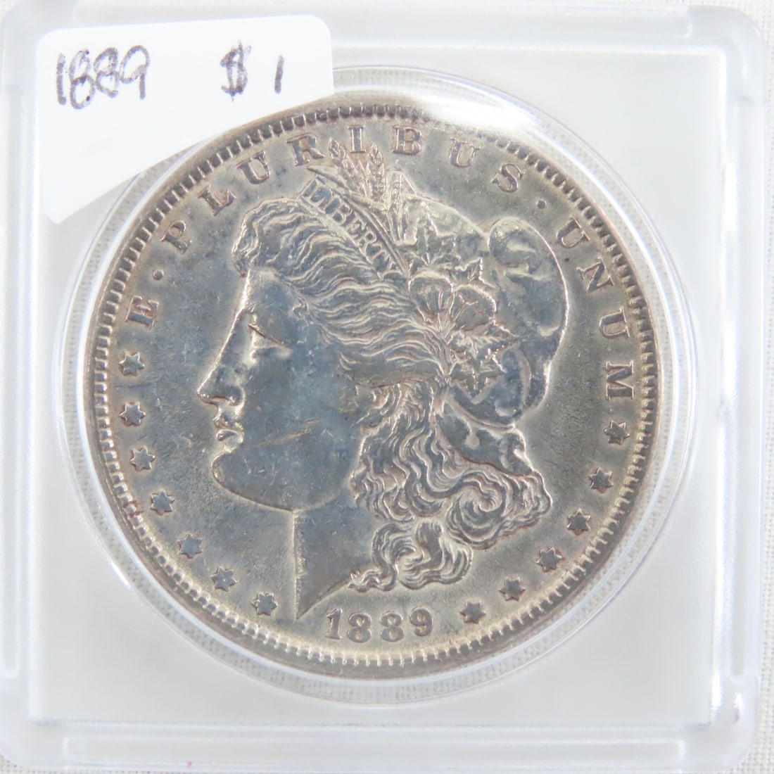 1889 Morgan Silver Dollar: 1889 Morgan Silver Dollar - Lot Size 2x2x1" 1 LB All information and photos are intended to be as accurate as possible, but errors are possible. No item may be returned or refused based on this
