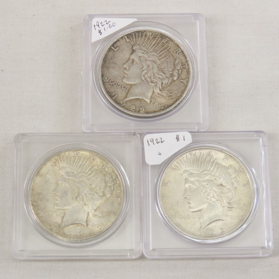 3 1922 Peace Silver Dollars, 2 P & 1 S mint: 3 1922 Peace Silver Dollars, 2 P & 1 S mint - Lot Size 2x2x2" 1 LB All information and photos are intended to be as accurate as possible, but errors are possible. No item may be returned or refused