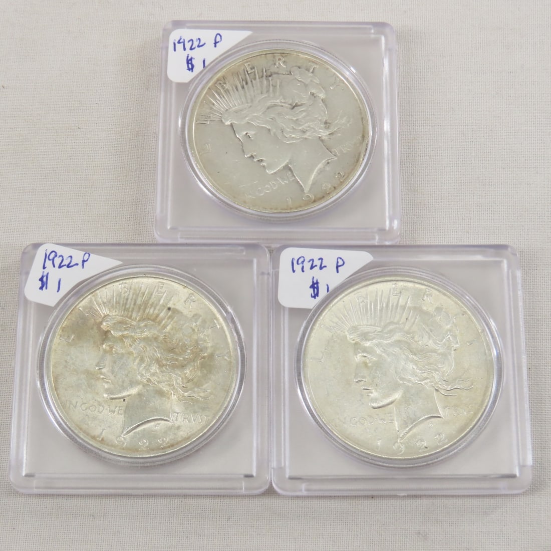 3 1922 P Peace Silver Dollars: 3 1922 P Peace Silver Dollars - Lot Size 2x2x2" 1 LB All information and photos are intended to be as accurate as possible, but errors are possible. No item may be returned or refused based on this in
