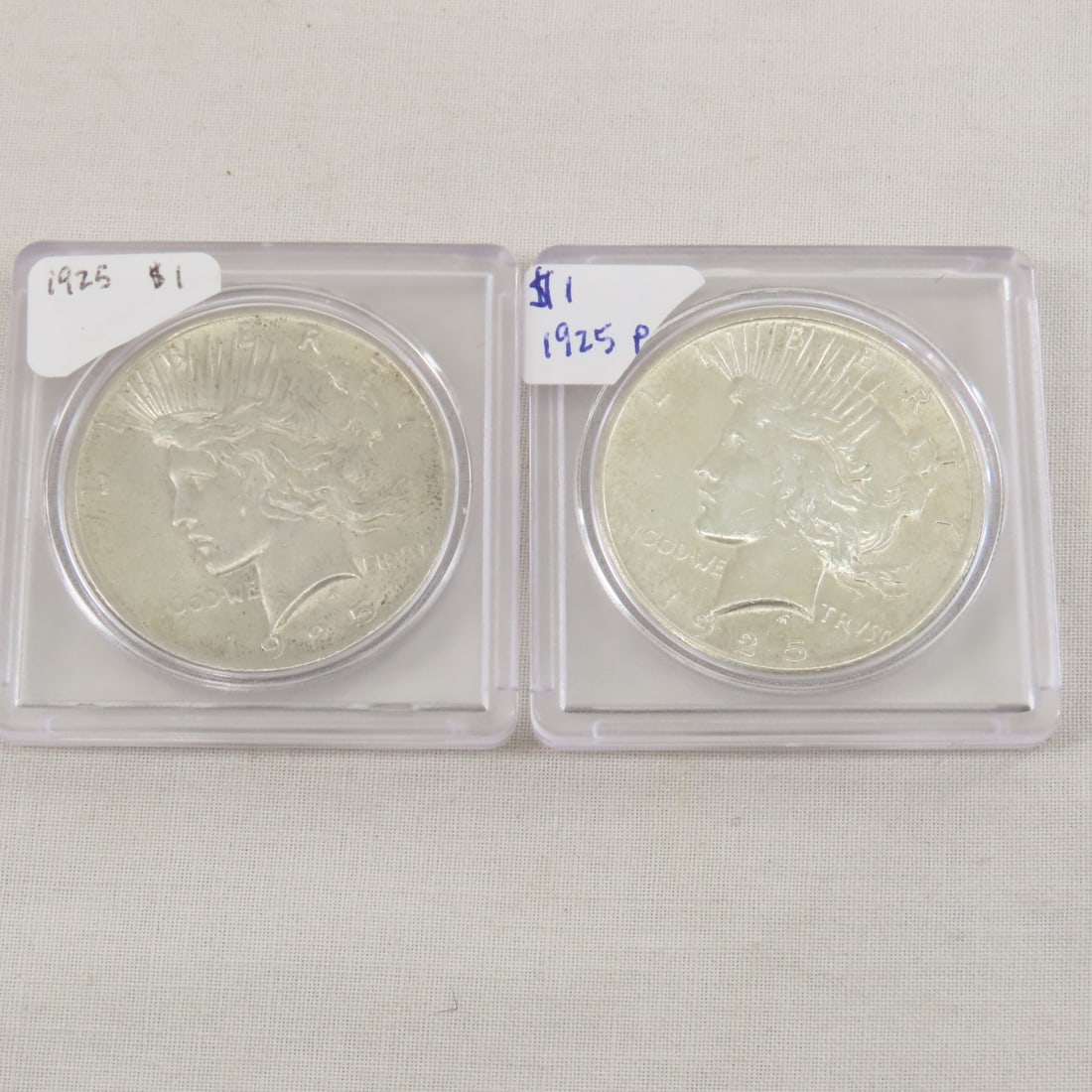 2 1925 Peace Silver Dollars: 2 1925 Peace Silver Dollars - Lot Size 2x2x2" 1 LB All information and photos are intended to be as accurate as possible, but errors are possible. No item may be returned or refused based on this