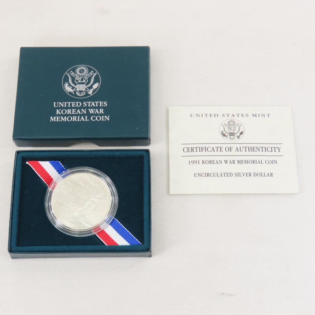 1991 Korean War Memorial Silver Dollar UNC: 1991 Korean War Memorial Silver Dollar UNC - with box and papers. Lot Size 4x3x1" 1 LB All information and photos are intended to be as accurate as possible, but errors are possible. No item may be re