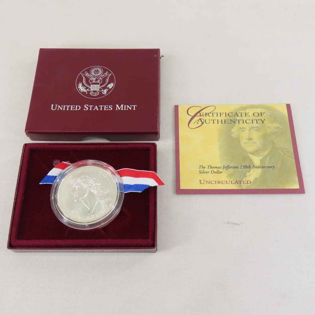 1993 Thomas Jefferson 250th Silver Dollar UNC: 1993 Thomas Jefferson 250th Silver Dollar UNC - with box and papers. Lot Size 4x3x1" 1 LB All information and photos are intended to be as accurate as possible, but errors are possible. No item may