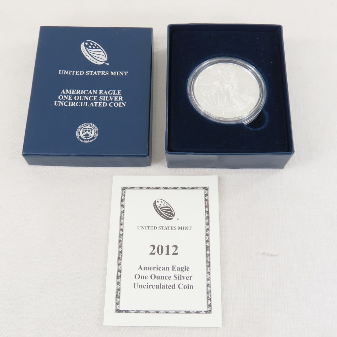 2012 American Silver Eagle UNC: 2012 American Silver Eagle UNC - with box and papers. Lot Size 4x3x1" 1 LB All information and photos are intended to be as accurate as possible, but errors are possible. No item may be returned or