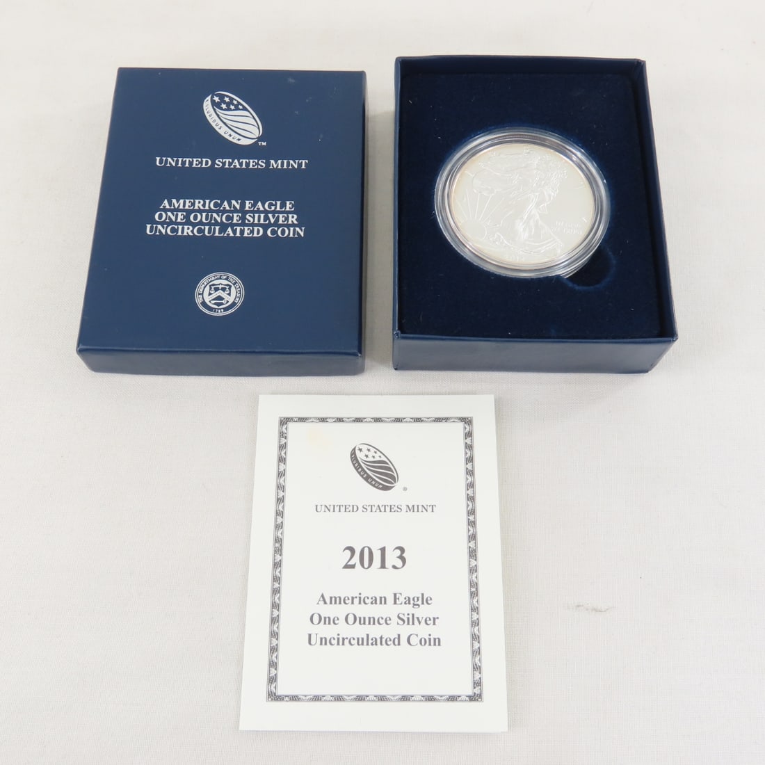 2013 American Silver Eagle UNC: 2013 American Silver Eagle UNC - with box and papers. Lot Size 4x3x1" 1 LB All information and photos are intended to be as accurate as possible, but errors are possible. No item may be returned or