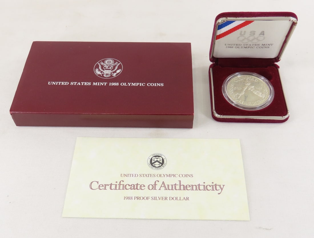 1988 S Olympic Silver Dollar & Half Dollar Proof: 1988 S Olympic Silver Dollar & Half Dollar Proof - with box and papers. Lot Size 6x4x1" 1 LB All information and photos are intended to be as accurate as possible, but errors are possible. No item may