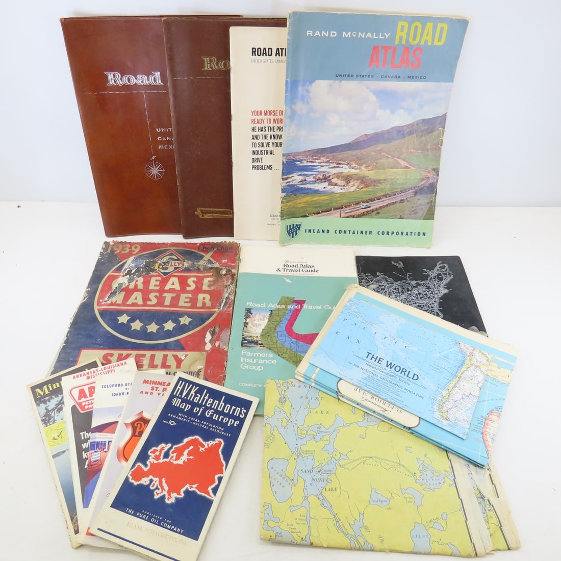 Vintage Road Atlases, Maps & 1939 Grease Master: Vintage Road Atlases, Maps & 1939 Grease Master - Grease Master Skelly Service Book (damage). LOT SIZE: 16x12x4", 10 LBS All information and photos are intended to be as accurate as possible, but erro