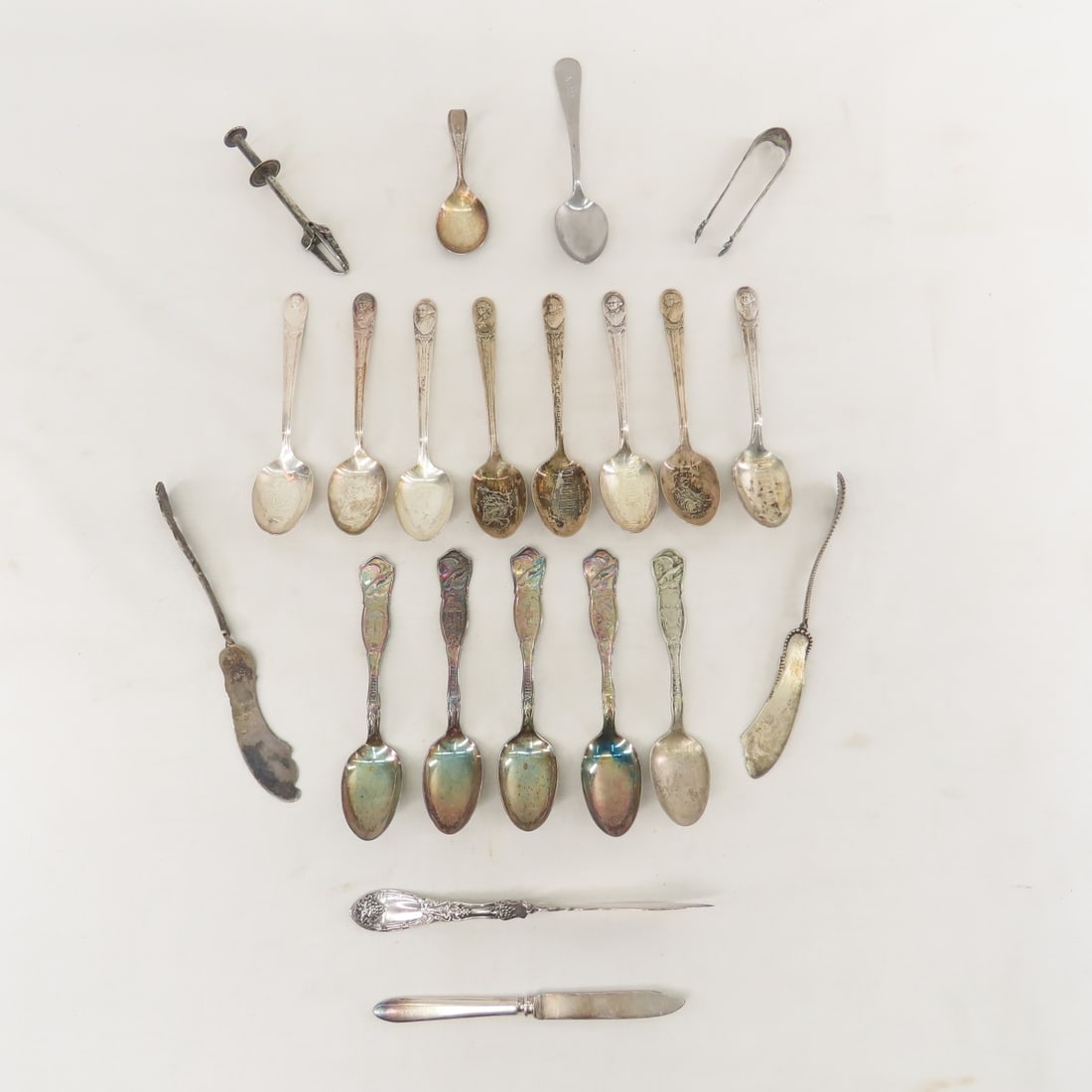 Presidential, State and Other Silverplate Pieces: Presidential, State and Other Silverplate Pieces - 8 Rogers Presidential spoons, EPNS sugar tong, ice tong, butter knife marked The Warren Co Warranted 12 DWT (did not test sterling), 5 state spoons,