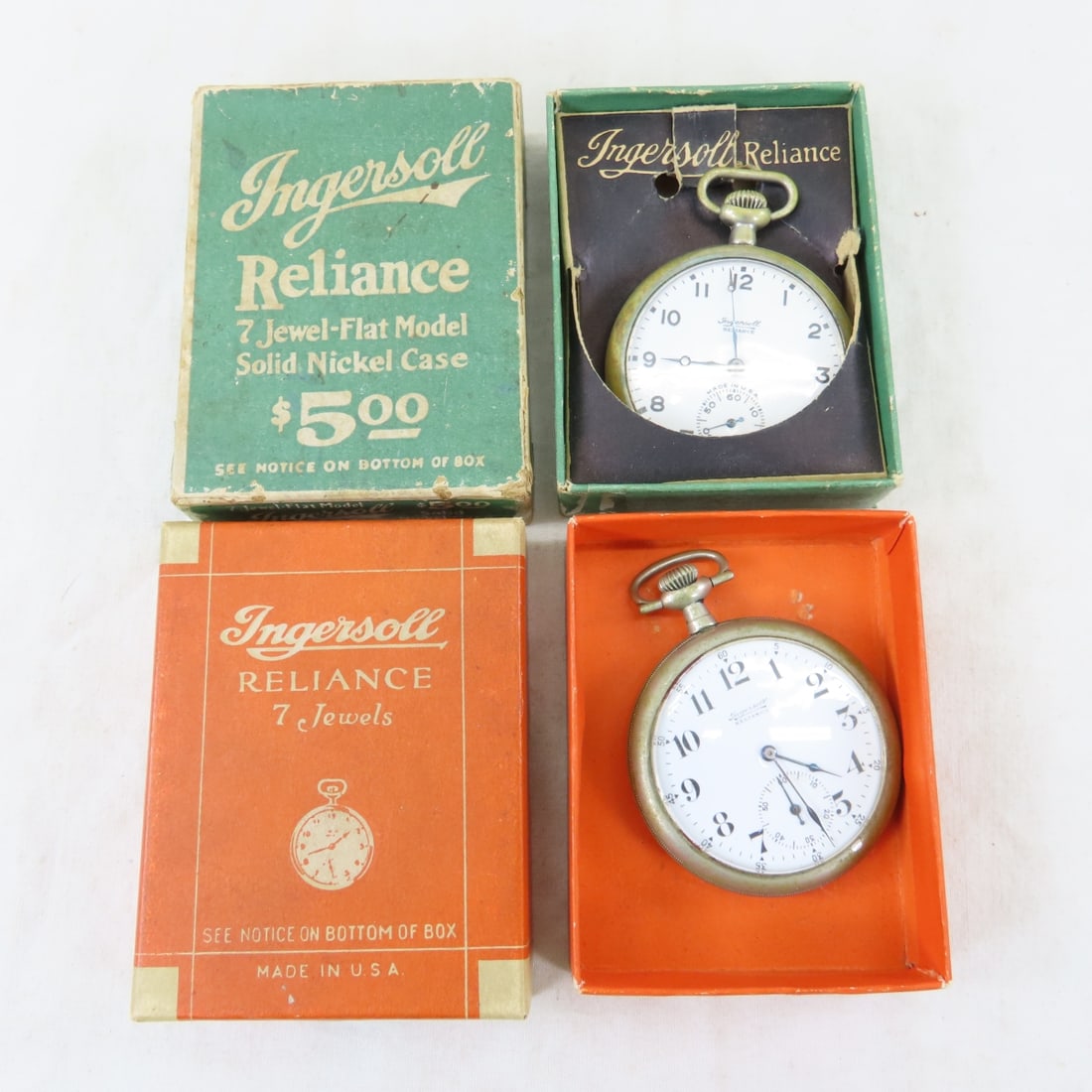 2 Ingersoll Reliance Pocket Watches in Boxes: 2 Ingersoll Reliance Pocket Watches in Boxes - 1910 grade: Radiolite Waterbury, 7 jewel, open face, working. SN# 71001 in green box. 1912 Ingersoll Waterbury grade, 7 jewel, open face, working, in ora