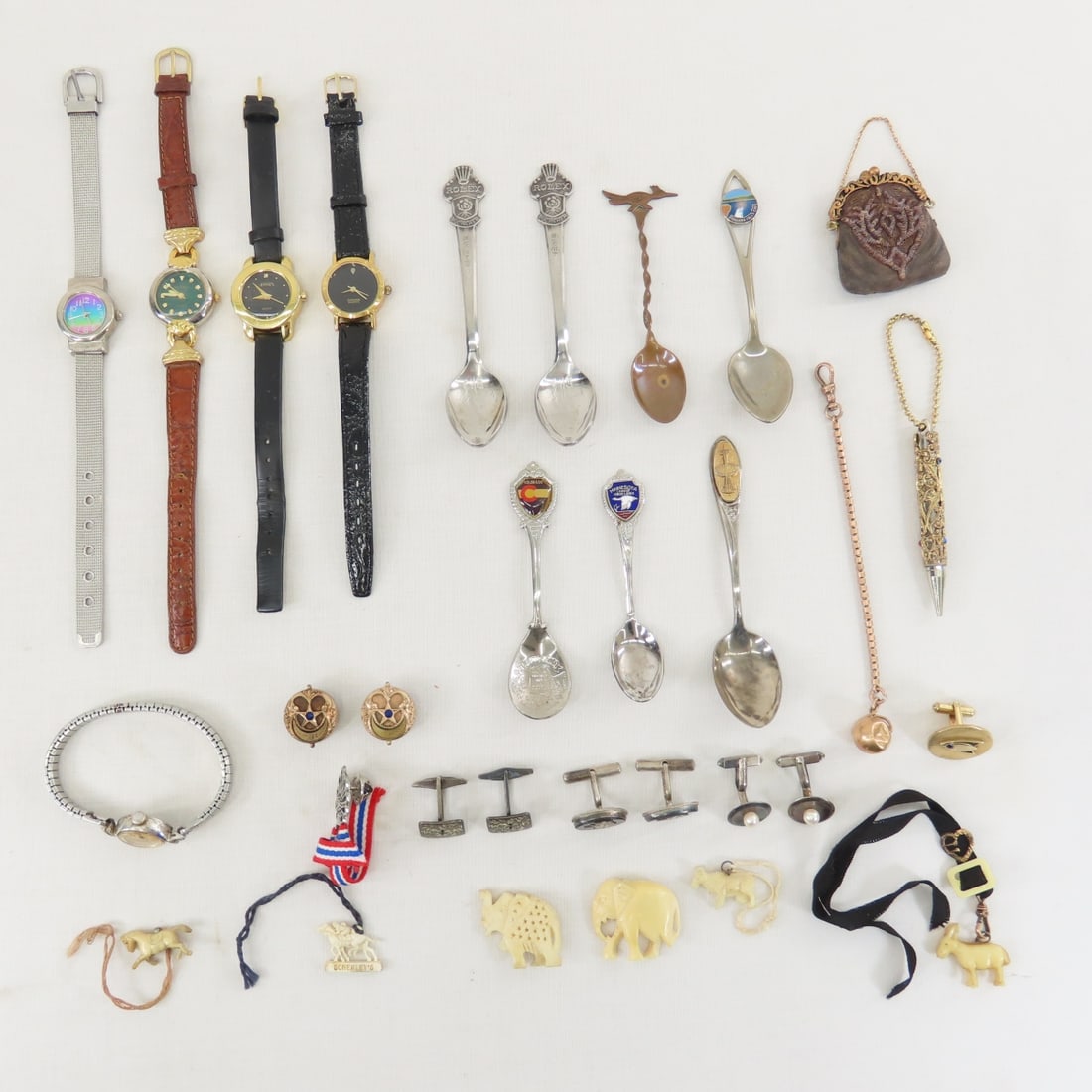 Watches, Spoons, Sterling Cufflinks & More: Watches, Spoons, Sterling Cufflinks & More - 1 pair sterling cufflinks, 2 others, ladies watches- not working, souvenir spoons, doll purse (does not open), faux ivory figures, and more. LOT SIZE: