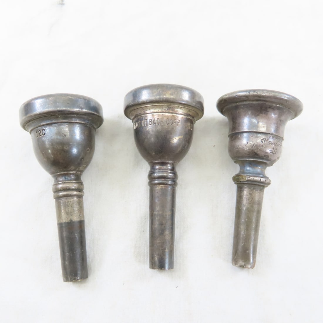 3 Vintage Trombone Mouthpieces, Bach 11C & 12C: 3 Vintage Trombone Mouthpieces, Bach 11C & 12C - Frank Holton 14. Lot Size 4x4x4" 2 LB All information and photos are intended to be as accurate as possible, but errors are possible. No item may be