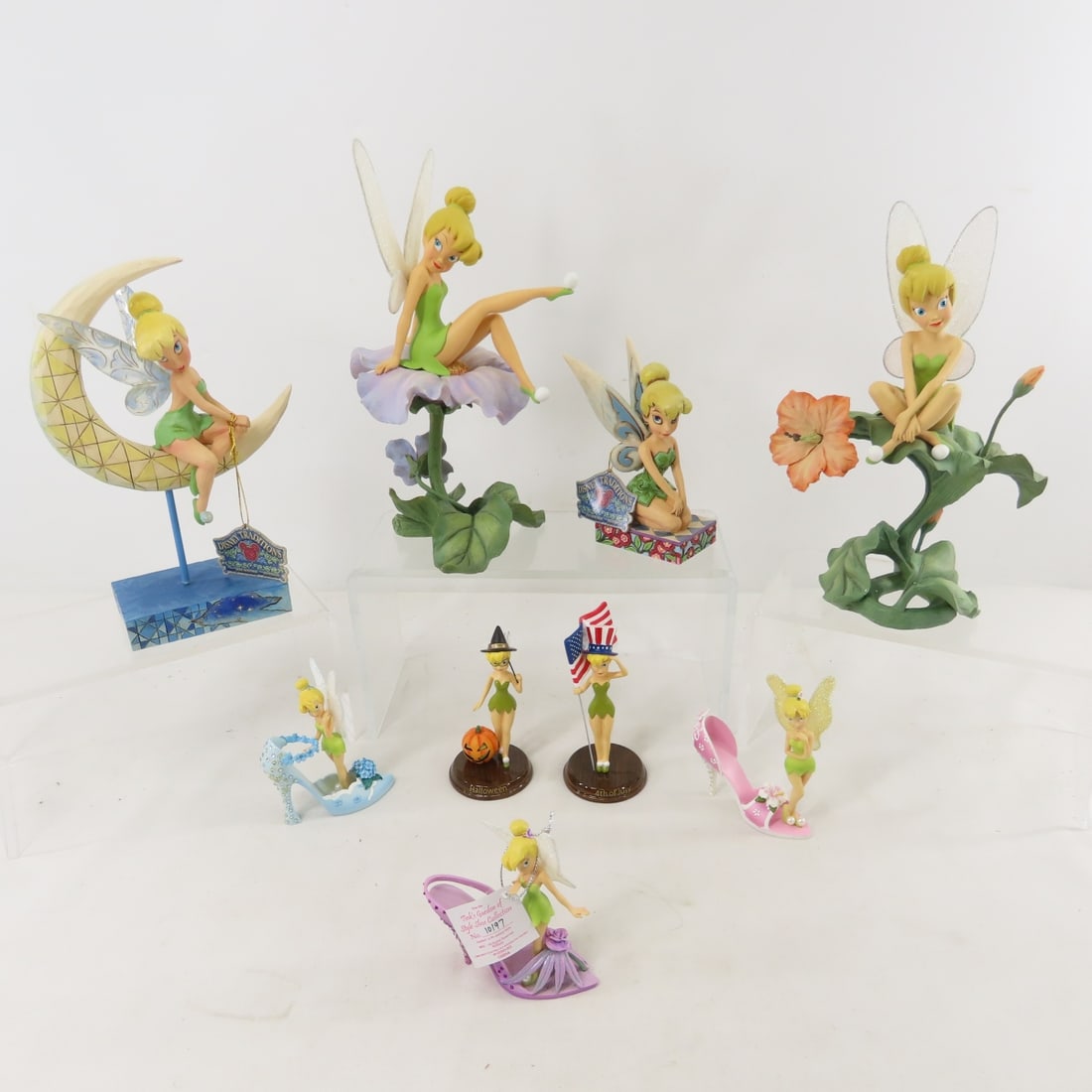 9 Jim Shore & Bradford Exchange TinkerBell Figures: 9 Jim Shore & Bradford Exchange TinkerBell Figures - 2 Jim Shore Enesco Walt Disney Showcase Collection Tinker Bell with hang Tags: "A Pixie Delight" and "Moonlight and Magic" (glued wing). 2 Bradex