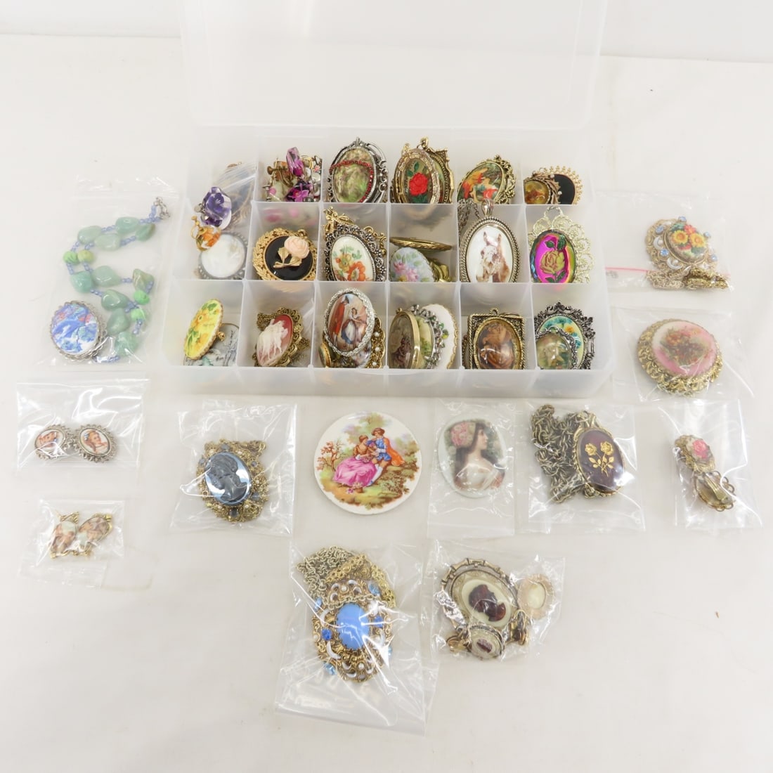 Vintage Cameo Style Pendants and Necklaces: Vintage Cameo Style Pendants and Necklaces - some acrylic flower earrings, some unmounted porcelain ovals. LOT SIZE: 11x8x6", 4 lbs All information and photos are intended to be as accurate as