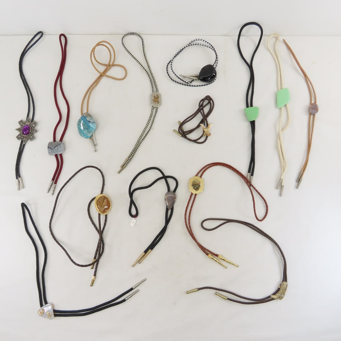 Vintage Bolo Ties: Vintage Bolo Ties - LOT SIZE: 8x8x8", 2 lbs All information and photos are intended to be as accurate as possible, but errors are possible. No item may be returned or refused based on this