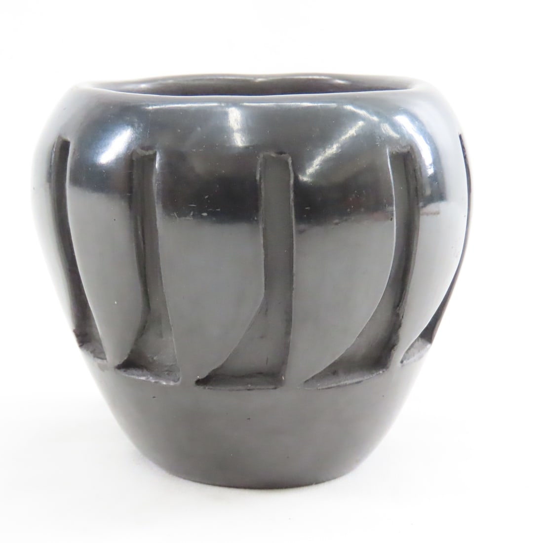 Stella Chavarria Carved Blackware Pottery Vase: Stella Chavarria Carved Blackware Pottery Vase - Santa Clara Pueblo Native, Signed. 4.5" Tall. No Cracks or Chips. Lot Size: 5x5x5", 2 lbs All information and photos are intended to be as accurate as 