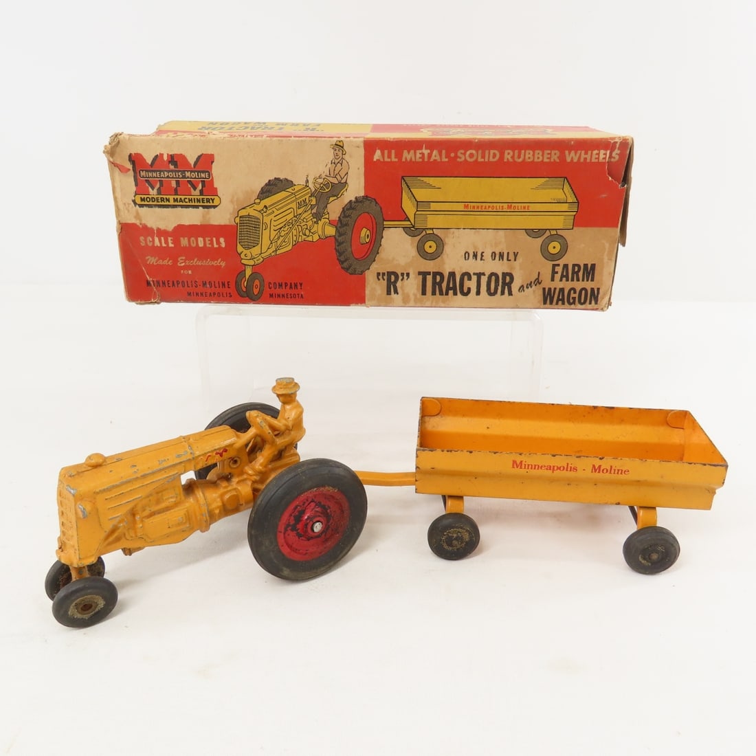 Minneapolis-Moline "R" Tractor and Farm Wagon: Minneapolis-Moline "R" Tractor and Farm Wagon - with original box - missing end flaps, made by SLIK, rubber tires. LOT SIZE: 11x4x4", 1 LB All information and photos are intended to be as accurate as