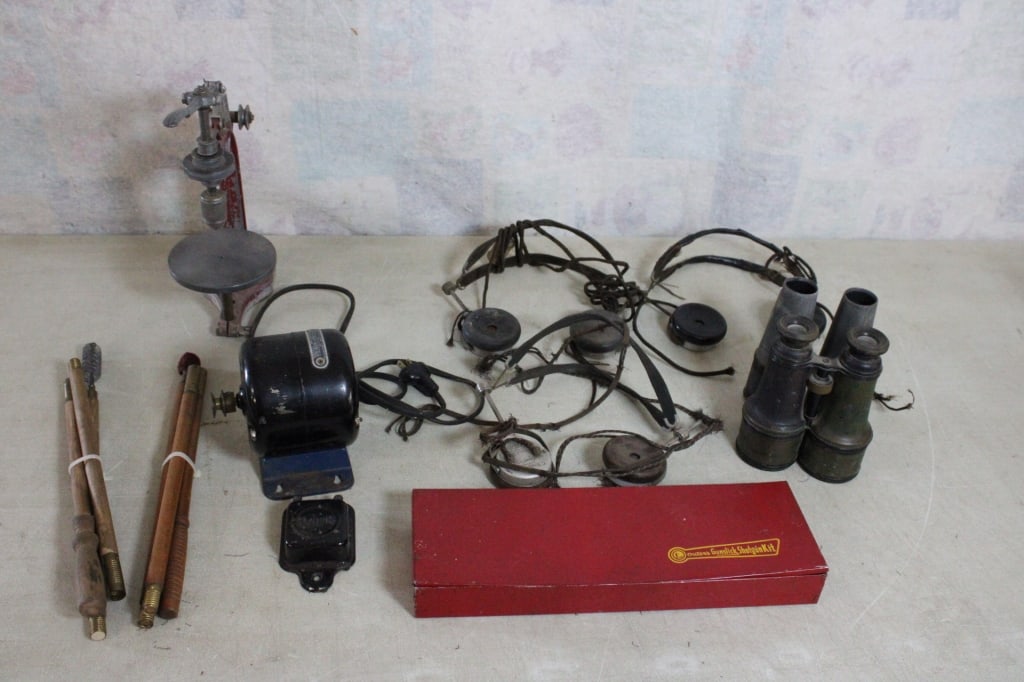 Old Head Phones, Binoculars, Motor, Drill Press: Old Head Phones, Binoculars, Motor, Drill Press - Antique Head Phones, Gun Cleaning Kit & Rod, Electric Motor, Drill Press, Binoculars (parts Missing). Lot Size 15" x 13" x 12". 19 Lbs. All