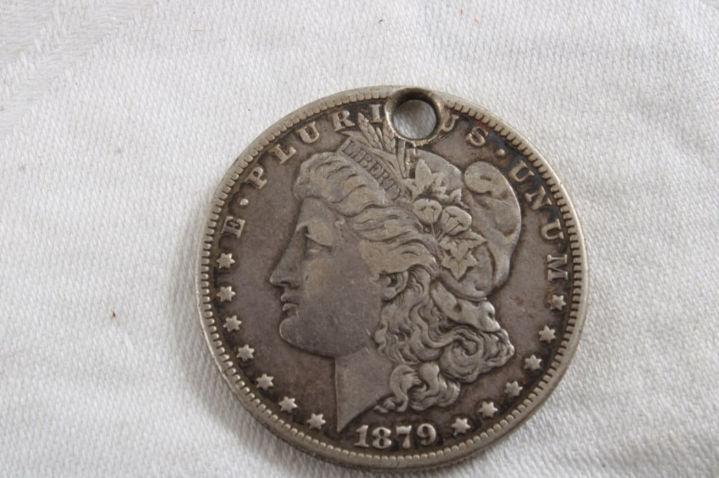 1879 Silver Dollar with Hole: 1879 Silver Dollar with Hole - Lot Size 3" x 3" x 1". .5 Lb. All information and photos are intended to be as accurate as possible, but errors are possible. No item may be returned or