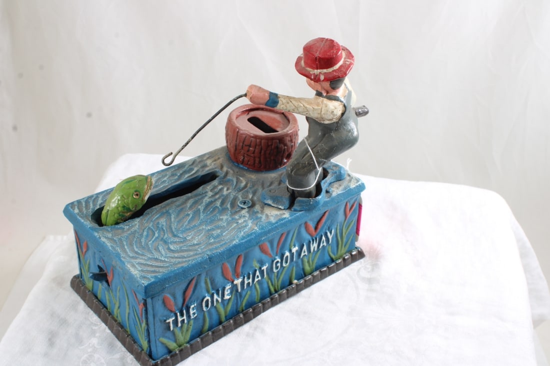 The One That Got Away Fisherman Cast Iron Bank: The One That Got Away Fisherman Cast Iron Bank - repro, Lot Size 7" x 7" x 7". 5 Lbs. All information and photos are intended to be as accurate as possible, but errors are possible. No item