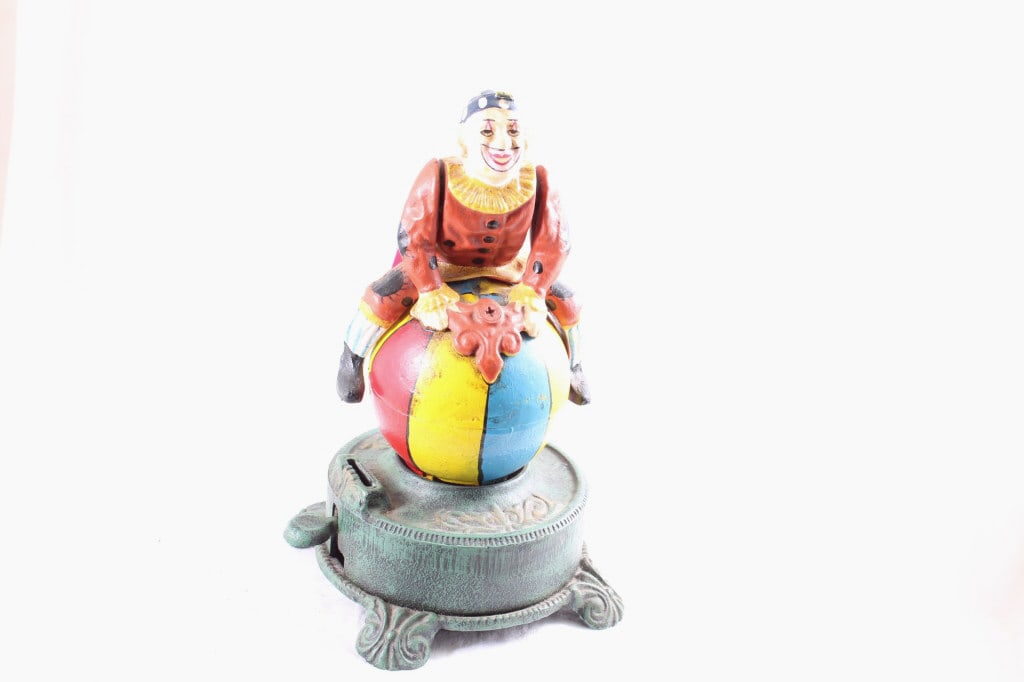 Cast Iron Mechanical Clown on Globe Bank: Cast Iron Mechanical Clown on Globe Bank - Spins around, but doesn't lock into place. repro, Lot Size 10" x 7" x 7". 7 Lbs. All information and photos are intended to be as accurate as possible,