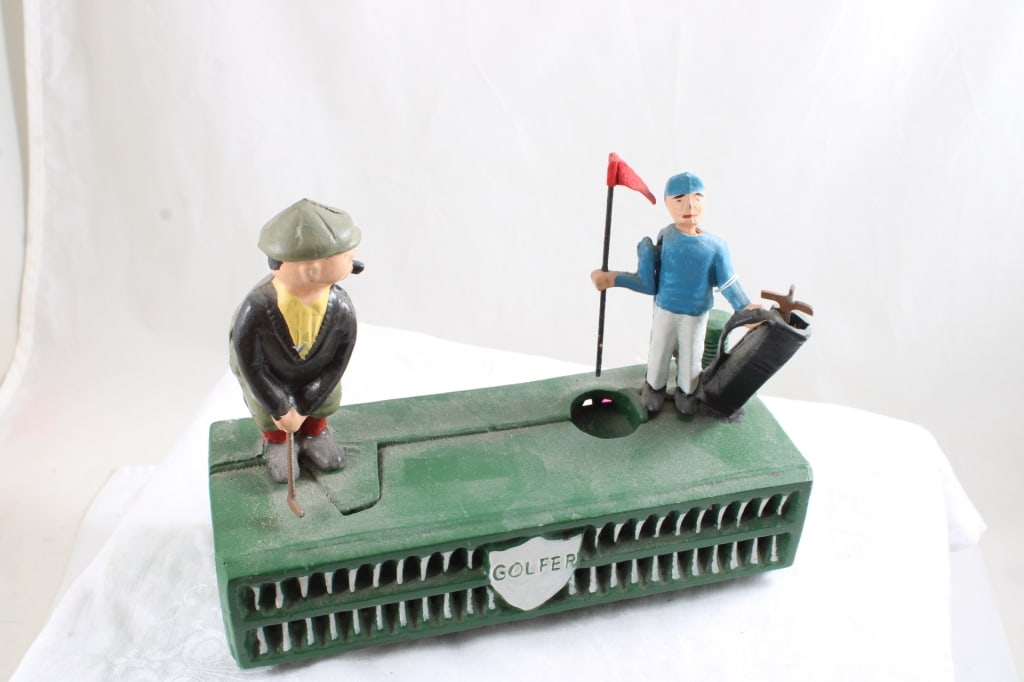 Cast Iron Golfer Mechanical Bank Works: Cast Iron Golfer Mechanical Bank Works - Golfer and Caddie. repro, Lot Size 8.5" x 3.5" x 7". 6 Lbs. All information and photos are intended to be as accurate as possible, but errors are