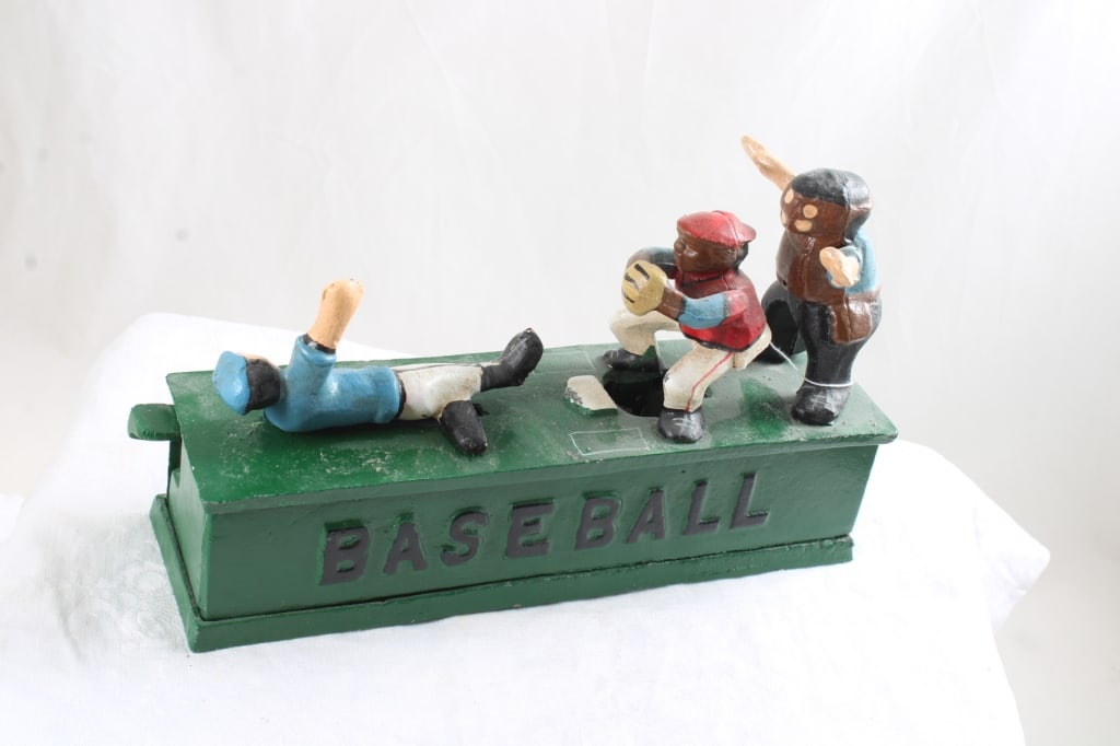 Cast Iron Baseball Mechanical Bank works: Cast Iron Baseball Mechanical Bank works - Baseball Player Sliding Home. repro, Lot Size 9" x 6" x 3". 5 Lbs. All information and photos are intended to be as accurate as possible, but errors are
