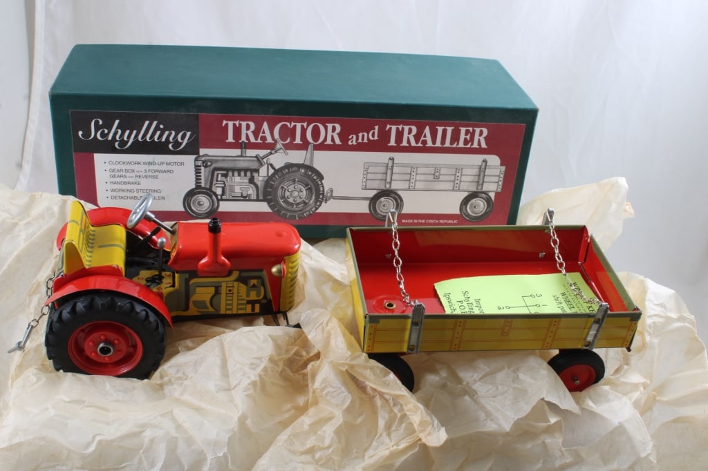 Schylling Wind Up Tractor & Wagon in Box with Key: Schylling Wind Up Tractor & Wagon in Box with Key - Lot Size 12" x 4" x 4". 2 Lbs. All information and photos are intended to be as accurate as possible, but errors are possible. No item