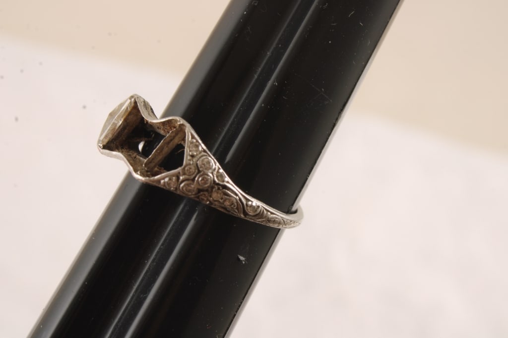 Tiffany & Co Platinum Ring With Diamonds 3.4grams: Tiffany & Co Platinum Ring With Diamonds 3.4grams - 1 large diamond and 20 small accent diamonds, Marked Tiffany & (the rest of the writing is worn off). Lot Size 2" x 2" x 1". .5 Lb. All