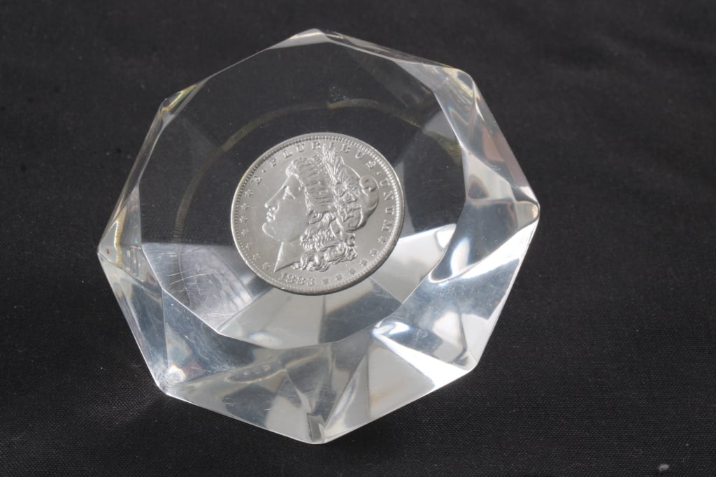 1883 O Morgan Silver Dollar Lucite Paperweight: 1883 O Morgan Silver Dollar Lucite Paperweight - Diamond Shaped Lucite Paperweight. Lot Size 4" x 4" x 3". 1 Lb. All information and photos are intended to be as accurate as possible, but errors