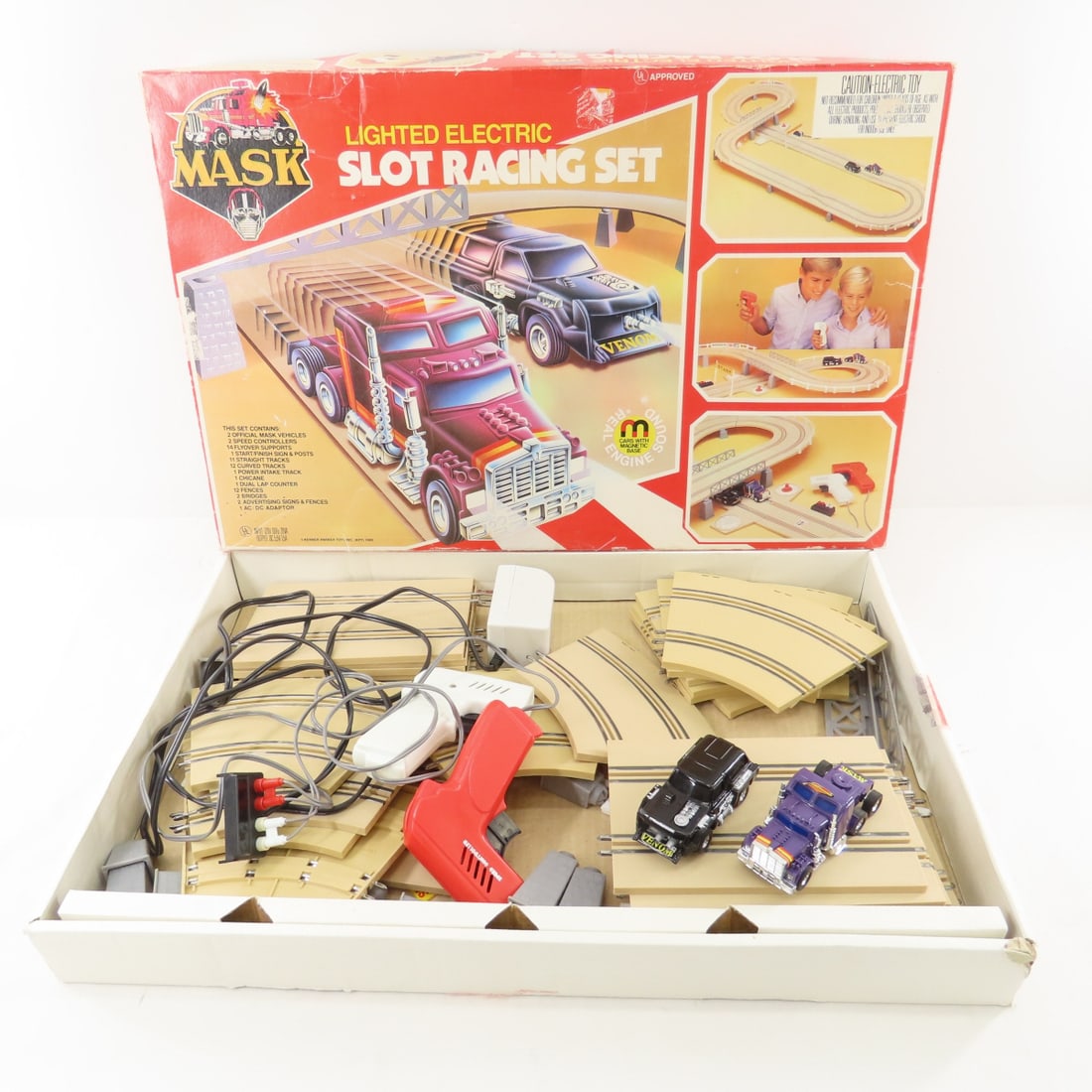 1985 MASK Lighted Electric Slot Racing Set in Box: 1985 MASK Lighted Electric Slot Racing Set in Box - Untested: Contents at least mostly complete, may be missing pieces. Lot Size: 22x14x3", 5 lbs All information and photos are intended to be as