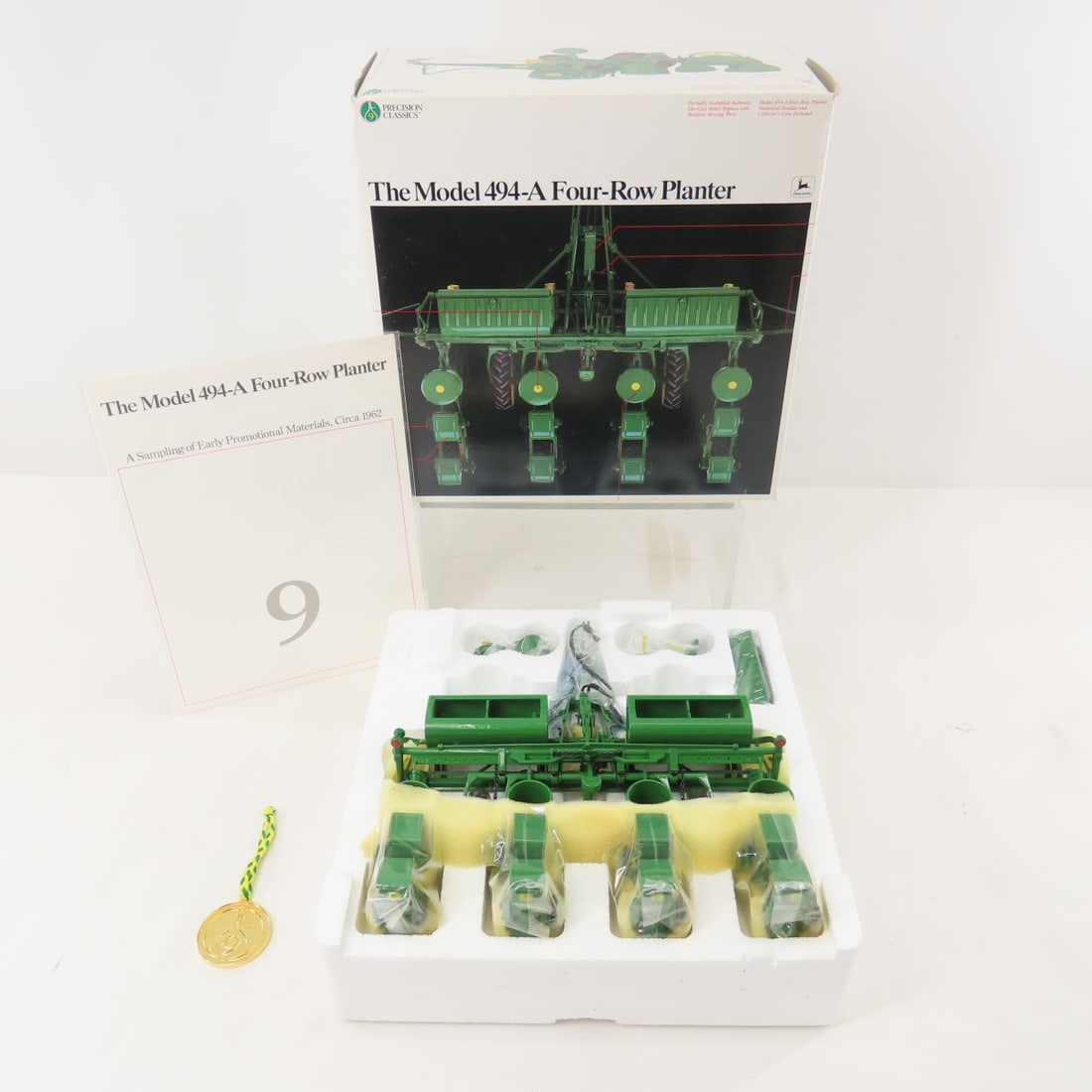 ERTL John Deere Precision Classics 494 Planter: ERTL John Deere Precision Classics 494 Planter - 1/16 Scale ERTL Diecast John Deere Precision Classics Model 494-A Four Row Planter with Collector's Coin, Open Box. Lot Size: 10x10x5", 2 lbs All