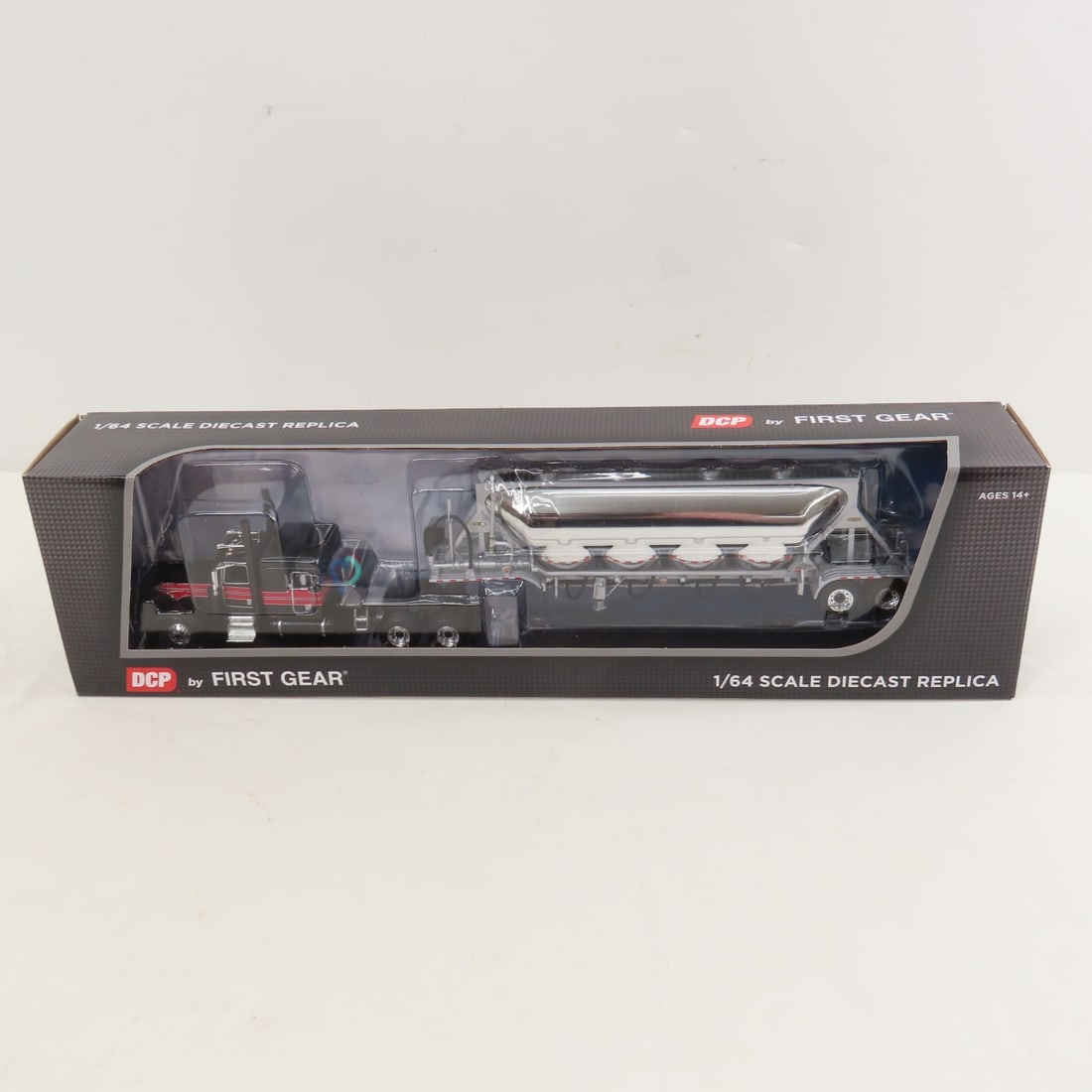 DCP First Gear 1:64 Scale Peterbilt 389 Sleeper: DCP First Gear 1:64 Scale Peterbilt 389 Sleeper - Black/Viper Red 60-1696, 1/64 Scale Peterbilt Model 389 with 63" Flat Top Sleeper & J & L Pneumatic Trailer. Lot Size: 16x4x3" 1 lb All information