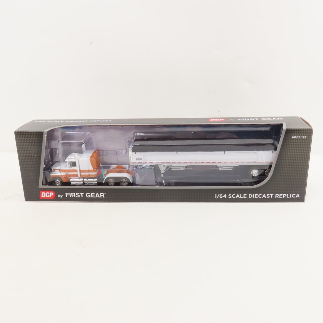 DCP First Gear 1:64 Scale Ford LTL-9000 Sleeper: DCP First Gear 1:64 Scale Ford LTL-9000 Sleeper - Orange/White 60-1798 1/64 Scale Ford LTL-9000 60" Flat Top Sleeper with Wilson Pacesetter Tandem Axle Grain Trailer. Lot Size: 16x4x3" 1 lb All inform