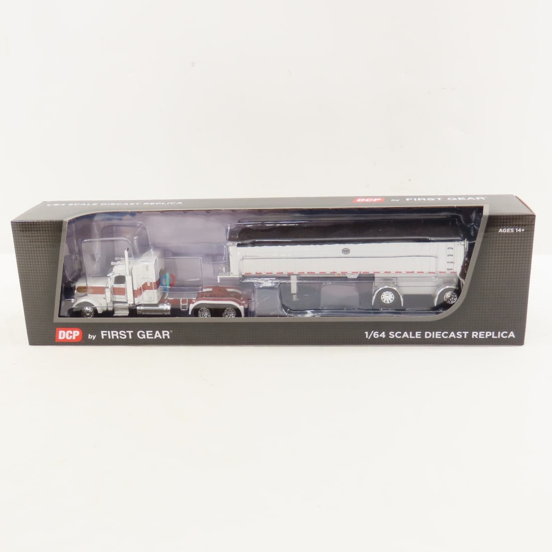 DCP First Gear 1:64 Scale Peterbilt 389 Sleeper: DCP First Gear 1:64 Scale Peterbilt 389 Sleeper - White/Red/Gold 60-1936 1/64 Scale Peterbilt Model 389 w/48" Mid Roof Sleeper & Mac Coal Dump Frameless Spread Axle Trailer. Lot Size: 16x4x3" 1 lb