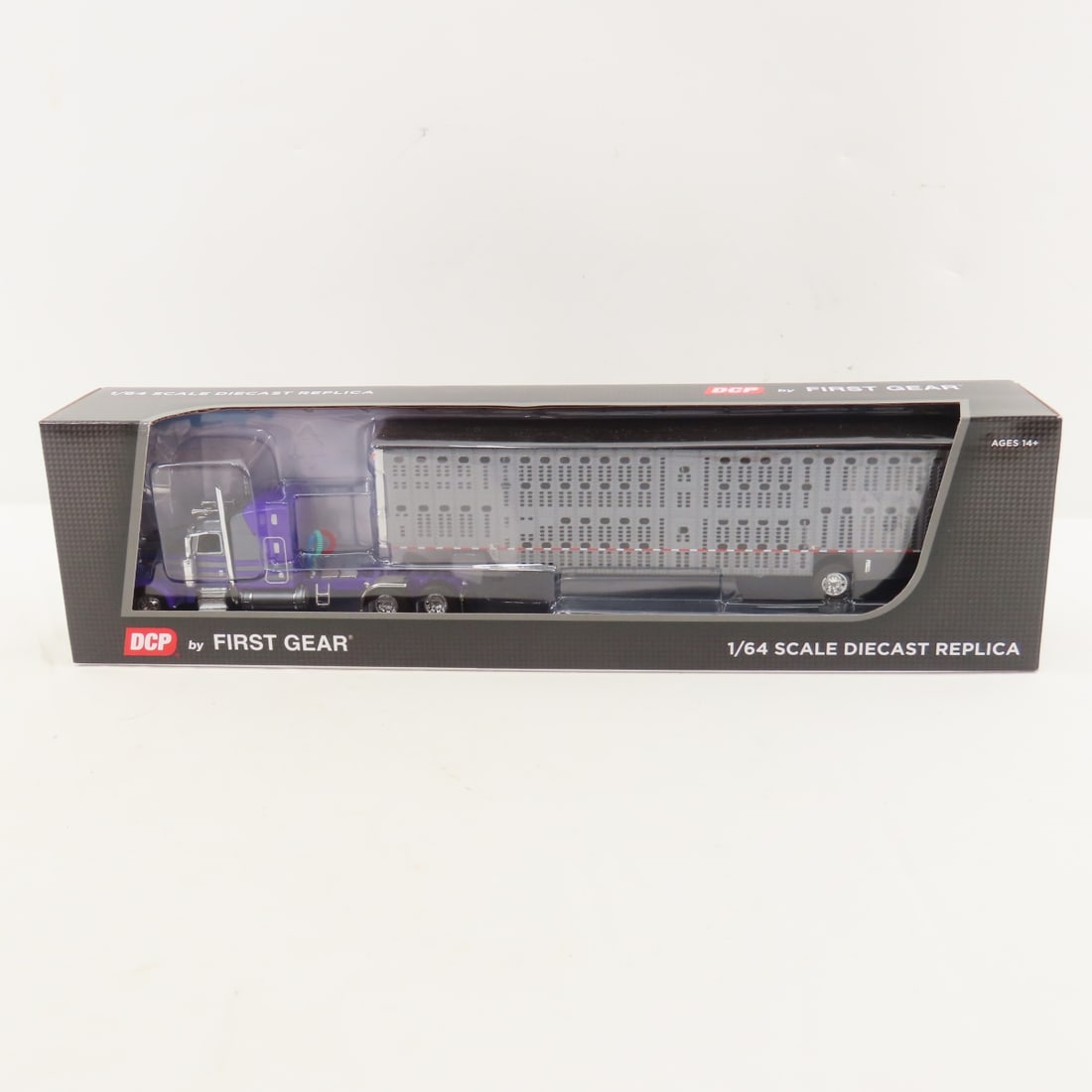 DCP First Gear 1:64 Scale Peterbilt 389 Sleeper: DCP First Gear 1:64 Scale Peterbilt 389 Sleeper - Gunmetal/Purple 60-1677 1/64 Peterbilt Model 389 with 63" Mid Roof Sleeper & Wilson Silverstar Spread Axle Livestock Trailer. Lot Size: 16x4x3" 1 lb