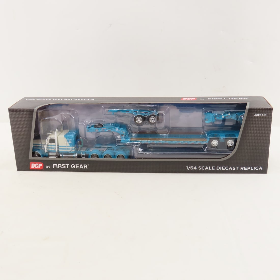 DCP First Gear 1:64 Scale Peterbilt 389 Sleeper: DCP First Gear 1:64 Scale Peterbilt 389 Sleeper - MC Blue/White 60-1438 1/64 Scale Peterbilt 389 63" Flattop Sleeper w/Fontaine Magnitude Lowboy Tri-Axle Trailer with Jeep & Stinger. Lot Size: