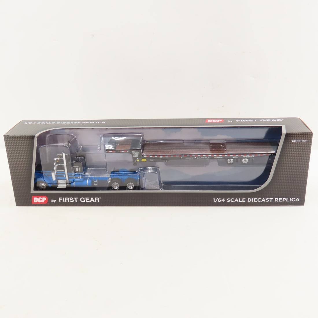 DCP First Gear 1:64 Peterbilt 389 Flattop/Trailer: DCP First Gear 1:64 Peterbilt 389 Flattop/Trailer - Blue/Black 60-2190 1/64 Scale Peterbilt 389 48" Flattop Sleeper with Landoll 440B-50CA Traveling Axle Trailer. Lot Size: 16x4x3" 1 lb All informatio