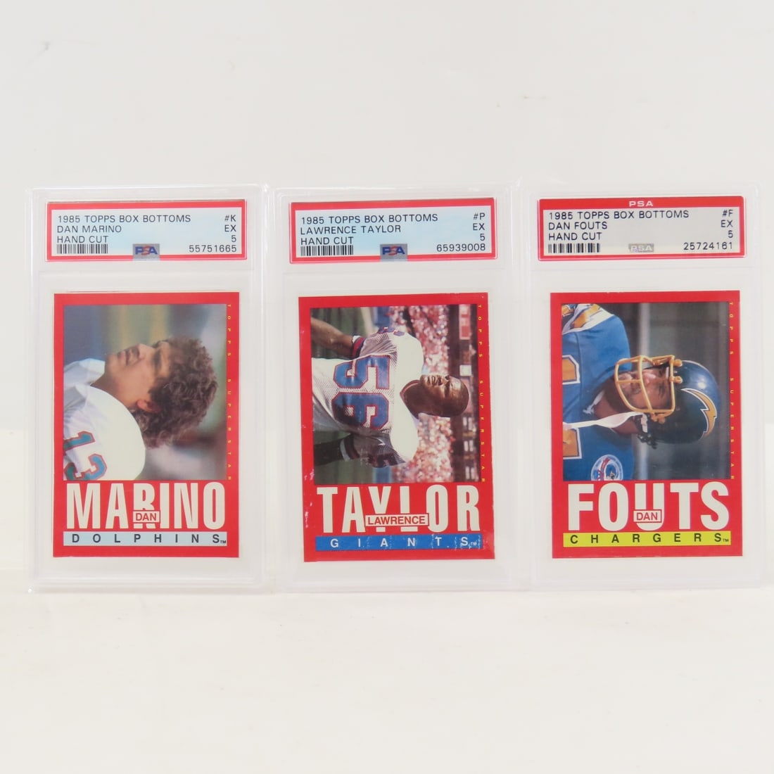 3 1985 Topps Box Bottoms Football Cards PSA 5 EX: 3 1985 Topps Box Bottoms Football Cards PSA 5 EX - 1985 Topps Box Bottoms Dan Marino #K PSA 5 EX, 1985 Topps Box Bottoms Dan Fouts #F PSA 5 EX, 1985 Topps Box Bottoms Lawrence Taylor PSA 5 EX. Lot
