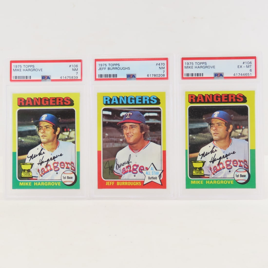 3 1975 Topps TX Rangers PSA graded Baseball Cards: 3 1975 Topps TX Rangers PSA graded Baseball Cards - 1975 Topps Jeff Burroughs #470 PSA 7 NM, 1975 Topps Mike Hargrove #106 PSA 7 NM, 1975 Topps Mike Hargrove #106 PSA 6 EX-MT.. Lot Size 6x4x2" 1 LB Al
