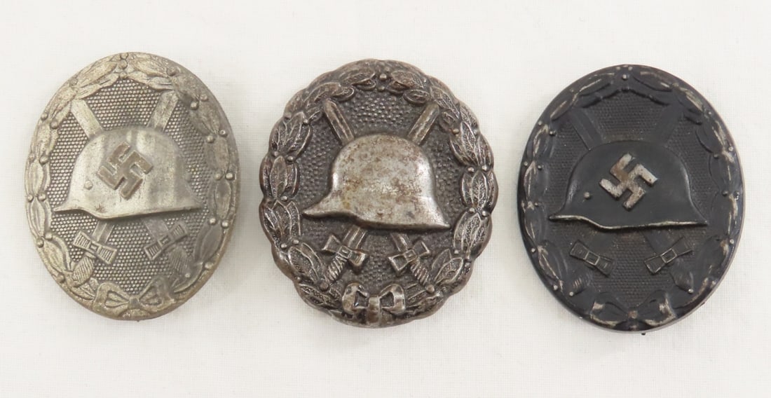 2 WWII & 1 WWI German Wound Badges: 2 WWII & 1 WWI German Wound Badges - 1 solid silver marked 65 & 1 hollow black WWI, 1 hollow black WWI. LOT SIZE 3x3x3" 1 LB All information and photos, which are part of the description) are