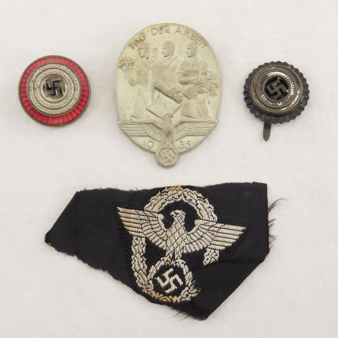 WWII German Tinnie, NSDAP Cockade, SS Police Cloth: WWII German Tinnie, NSDAP Cockade, SS Police Cloth - 2 NSDAP Visor Cap Cockades, Laboy Day Tinnie, SS Police BeVo cap eagle - cut or torn. LOT SIZE 3x3x3" 1 LB All information and photos, which are pa