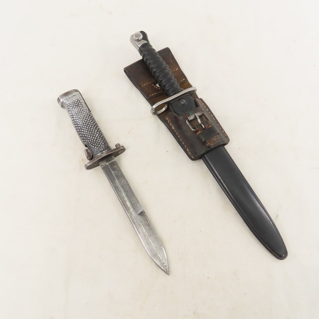 Late Wenger Swiss Army M57 & Turkish M5 Bayonets: Late Wenger Swiss Army M57 & Turkish M5 Bayonets - 9.5" blade, Ricasso (left): stylized "F" over "+W" inside a circle. (right) W 204228, guard: KV 144, 14.5" OAL. Scabbard: (Body reverse): mold marks