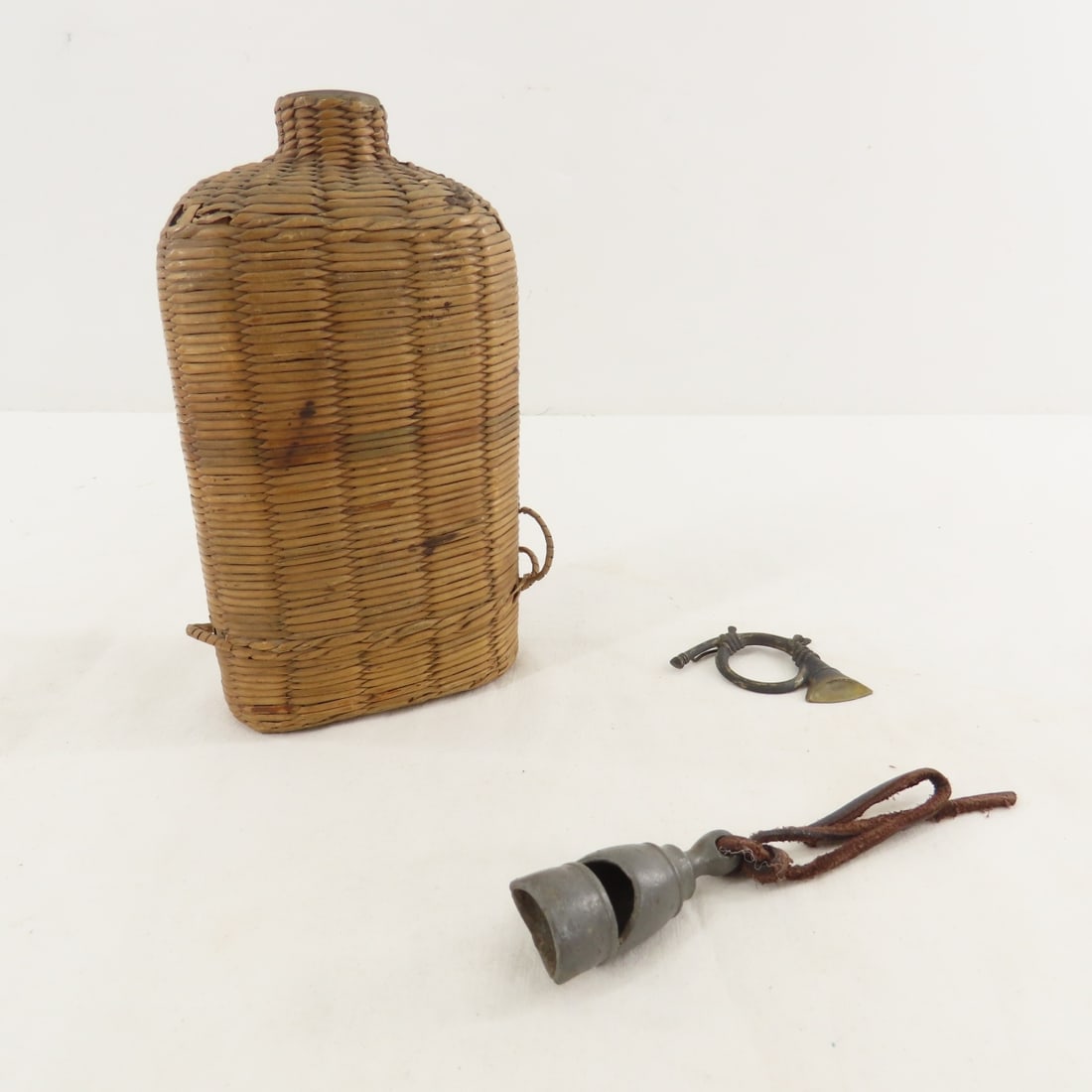 Civil War Era Flask, Police Whistle, Cap Insignia: Civil War Era Flask, Police Whistle, Cap Insignia - Wicker covered glass flask. LOT SIZE: 6x4x4" 3 LBS All information and photos, which are part of the description) are intended to be as accurate as