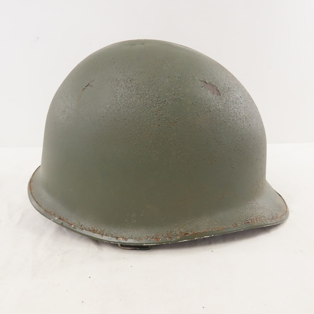 WWII US M1 Helmet with Liner: WWII US M1 Helmet with Liner - Chin strap is complete but not attached to 1 side. ROTH written on liner. LOT SIZE: 12x10x8" 4 LBS All information and photos, which are part of the description) are int