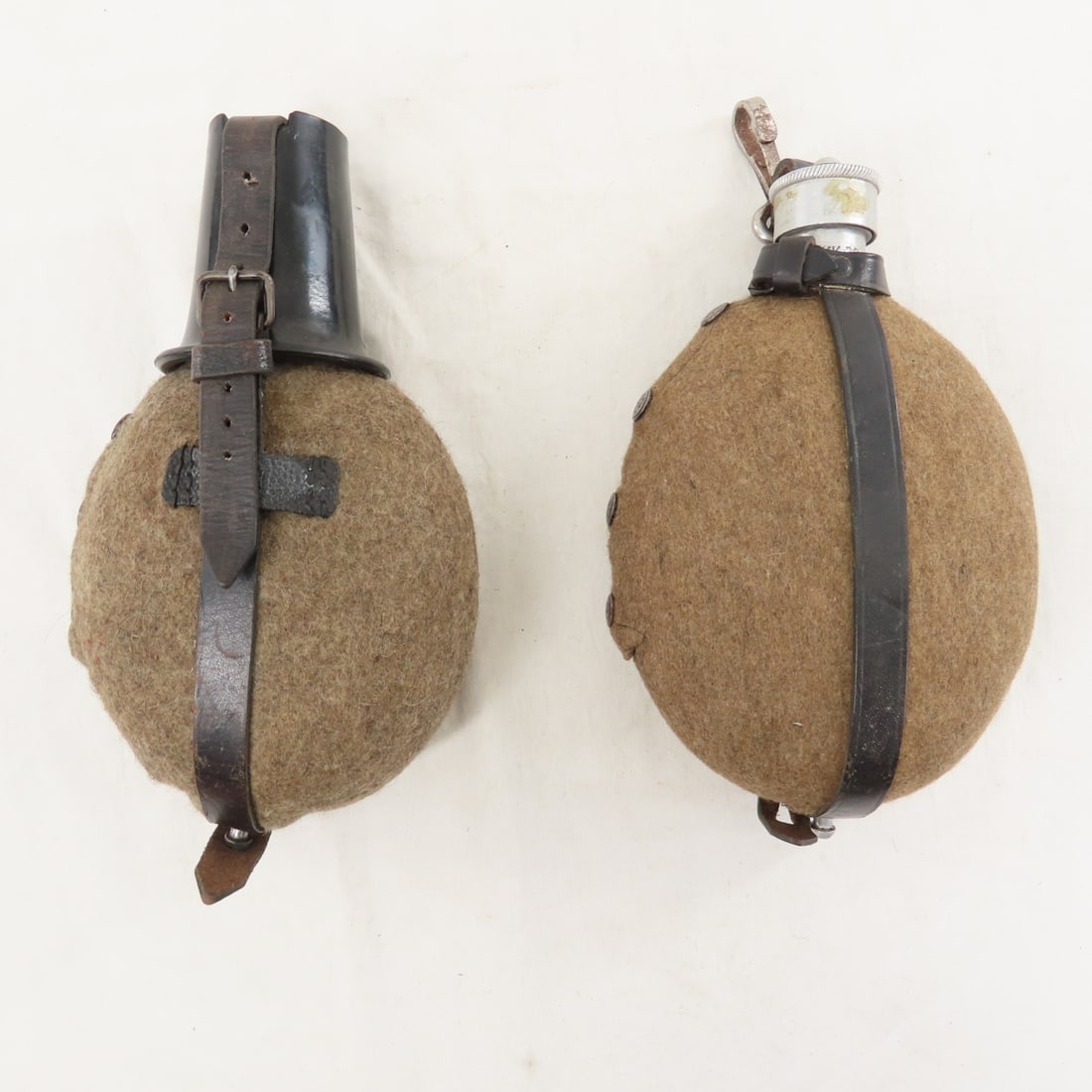 2 WWII German Canteens, 1 with Bakelite cup: 2 WWII German Canteens, 1 with Bakelite cup - LOT SIZE: 10x8x6" 2 LBS All information and photos, which are part of the description) are intended to be as accurate as possible, but errors are