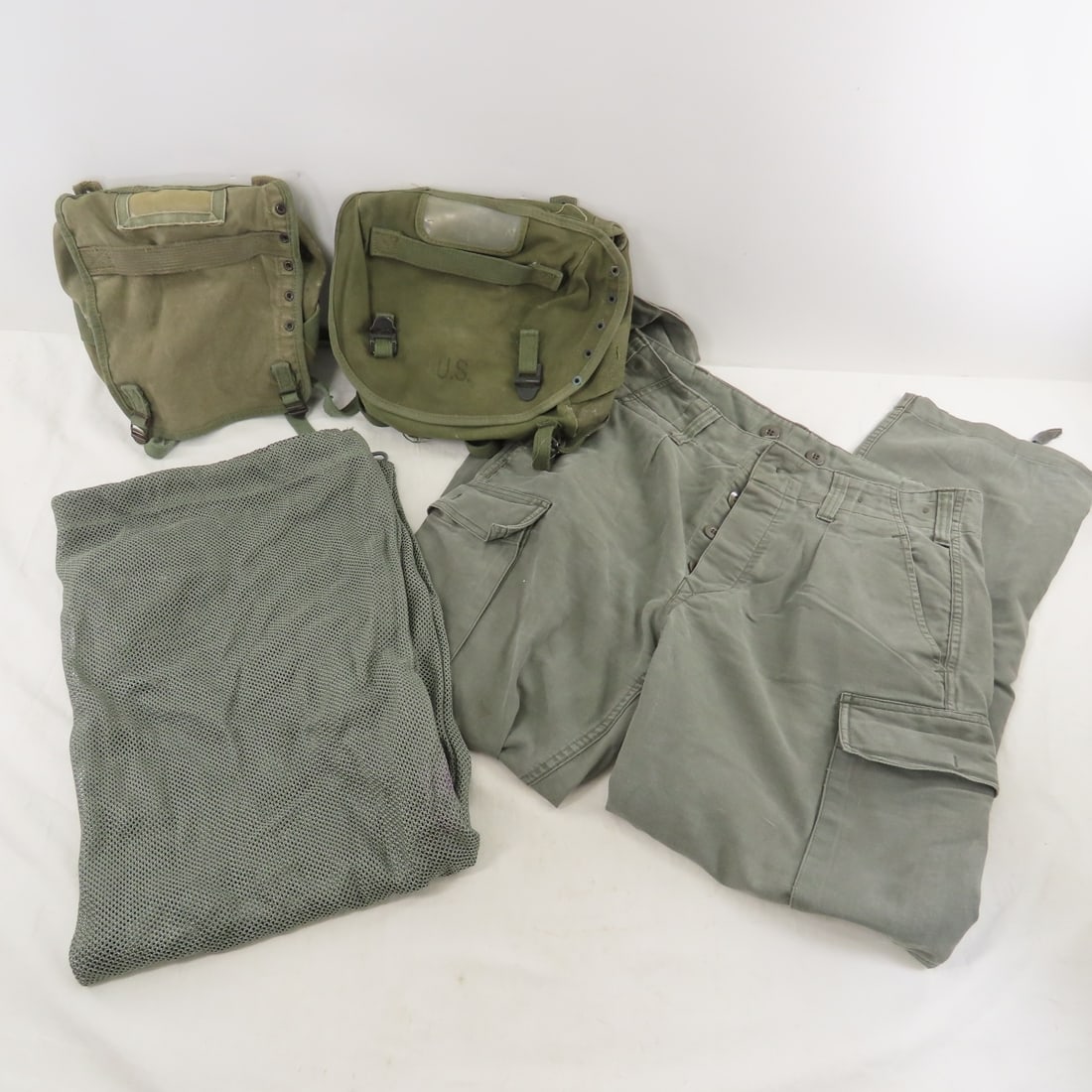 2 Post WWII US Field Packs, German Pants & Bag: 2 Post WWII US Field Packs, German Pants & Bag - 1992 Olive drab German pants size 7, German laundry bag, LOT SIZE: 12x11x5" 2 LBS All information and photos, which are part of the description) are