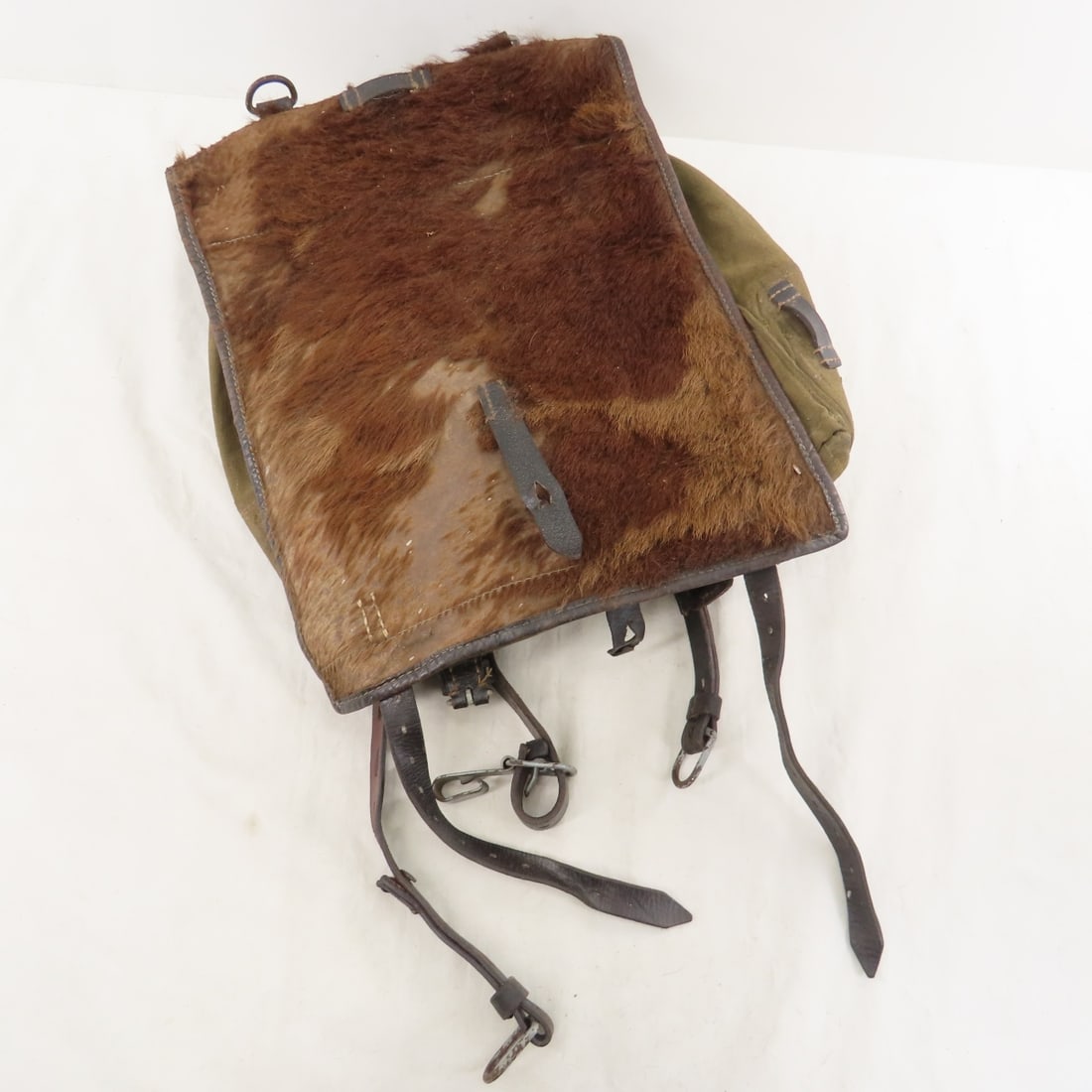WWII German Tornister M39 Cowhide Backpack: WWII German Tornister M39 Cowhide Backpack - some fur/hair is worn off. LOT SIZE: 16X14X3" 3 LBS All information and photos, which are part of the description) are intended to be as accurate as