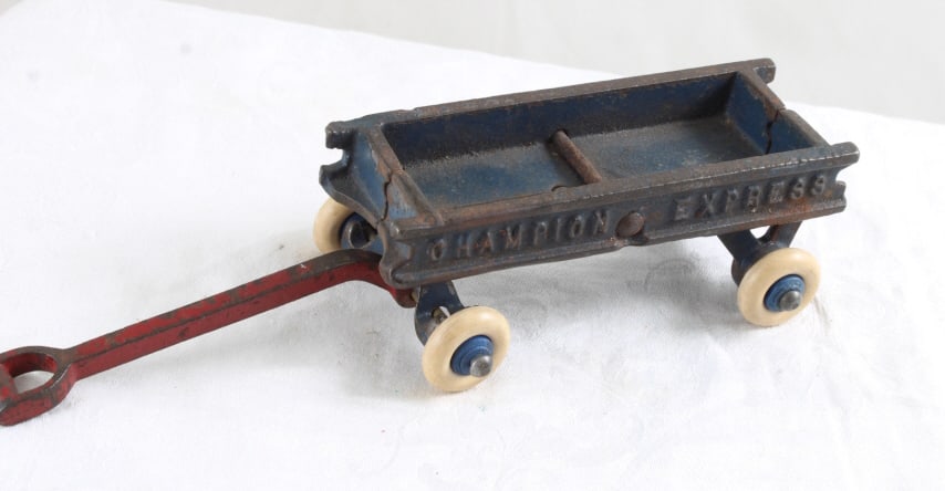 1930s Champion Express Cast Iron Pull Wagon: 1930s Champion Express Cast Iron Pull Wagon - Lot Size 5" x 2" x 2". 2 Lbs. All information and photos, which are part of the description, are intended to be as accurate as possible, but errors are
